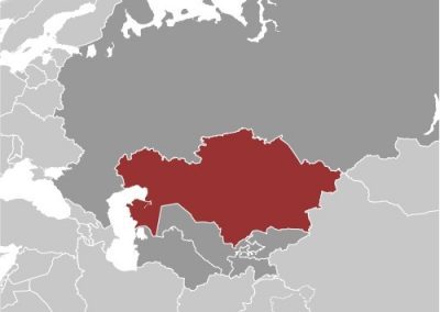 A map highlighting Kazakhstan in red, with neighbouring countries and regions in grey. Russia lies to the north, China to the east, and the Caspian Sea is visible west of Kazakhstan.
