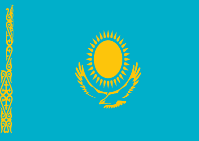 Flag of Kazakhstan: Featuring a sky blue background, the flag displays a gold sun above a soaring gold steppe eagle in the centre, with Kazakhstan's national ornamental pattern in gold along the left edge.